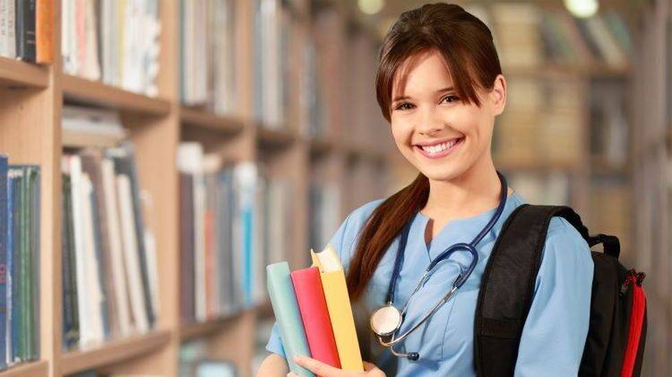 Nurse student in library with backpack and books